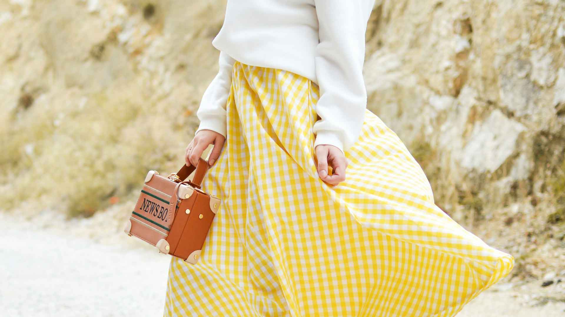 Yellow spring fashion skirt with white oversized sweater.